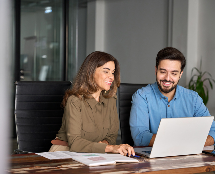 two business people meeting in office on laptop